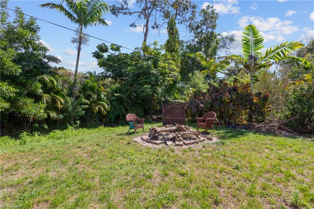19053 Holly Road Fort Myers, FL 33967 - Photo 14 of 21 a backyard of a house with table and chairs