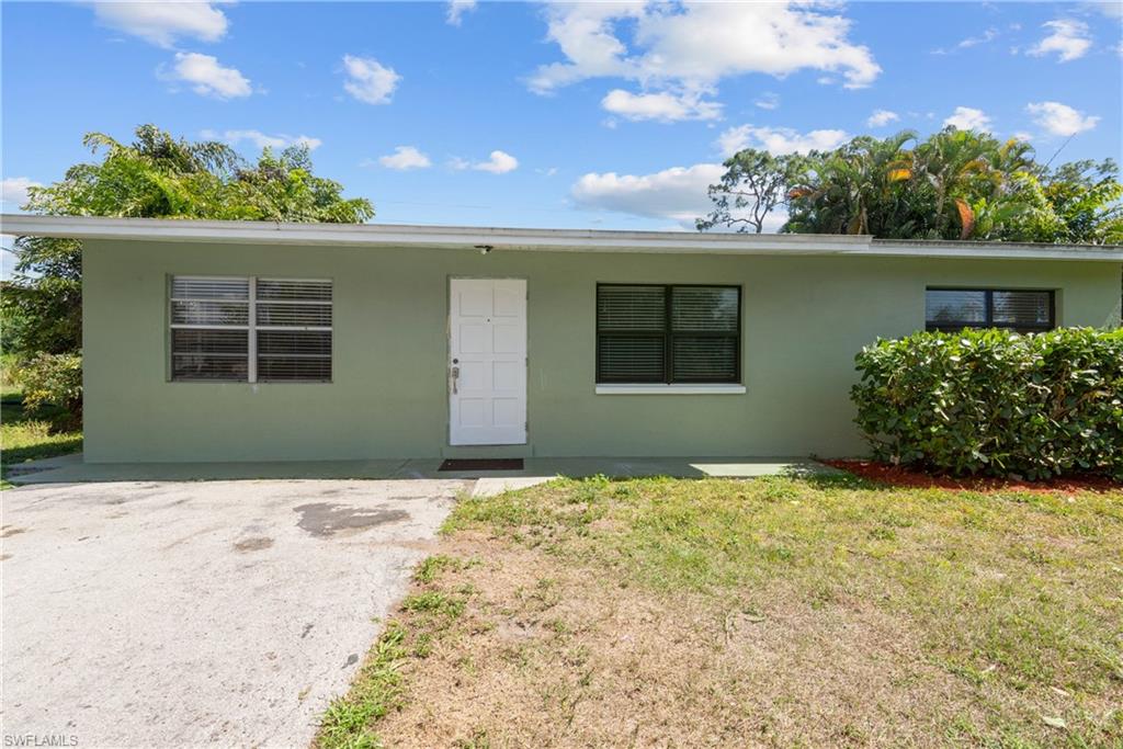 19053 Holly Road Fort Myers, FL 33967 - Photo 17 of 21 front view of a house with a yard