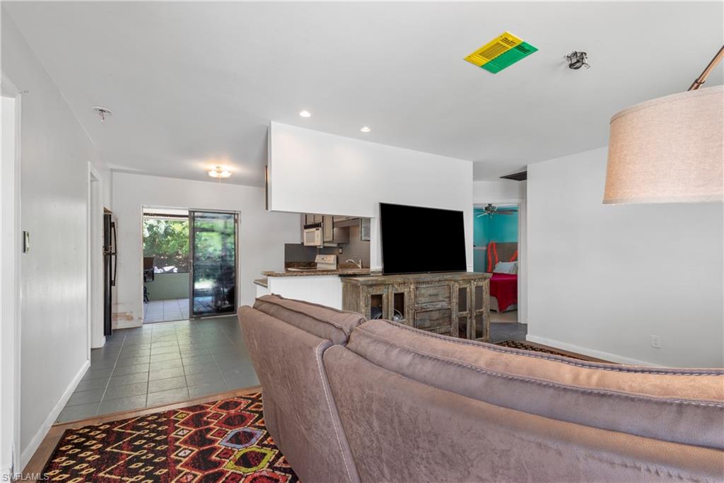 19053 Holly Road Fort Myers, FL 33967 - Photo 5 of 21 a living room with furniture and a flat screen tv