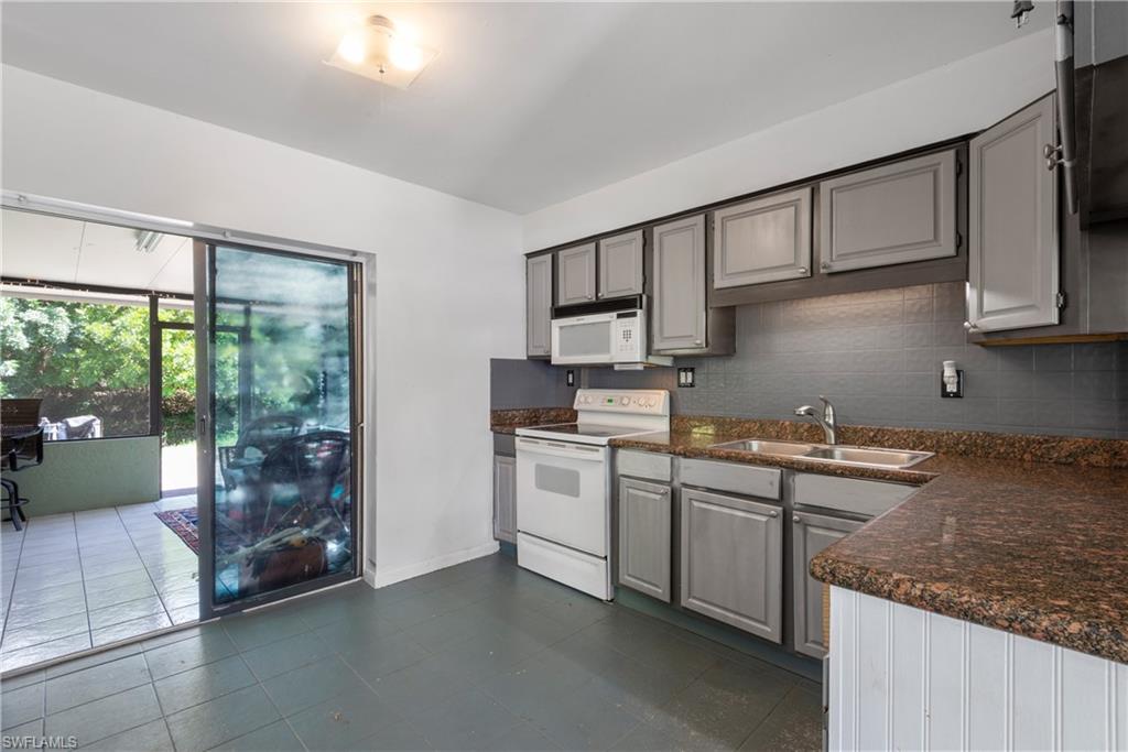 19053 Holly Road Fort Myers, FL 33967 - Photo 7 of 21 a kitchen that has a sink and a stove