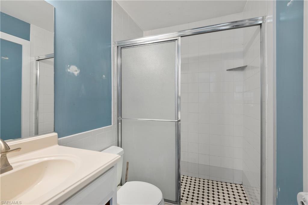 19053 Holly Road Fort Myers, FL 33967 - Photo 10 of 21 a bathroom with a shower and a toilet