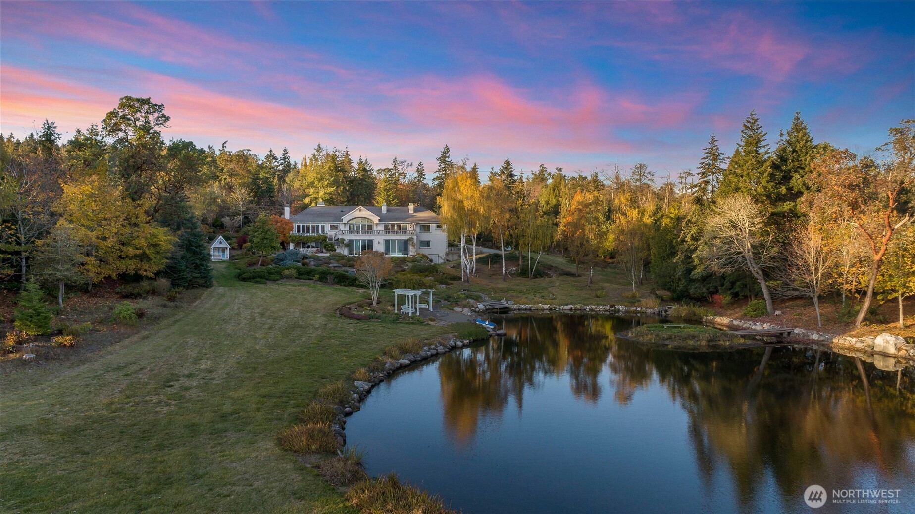 4205 Southwest Point Robinson Road Vashon, WA 98070 - Photo 3 of 40 a view of a lake with a house in the background