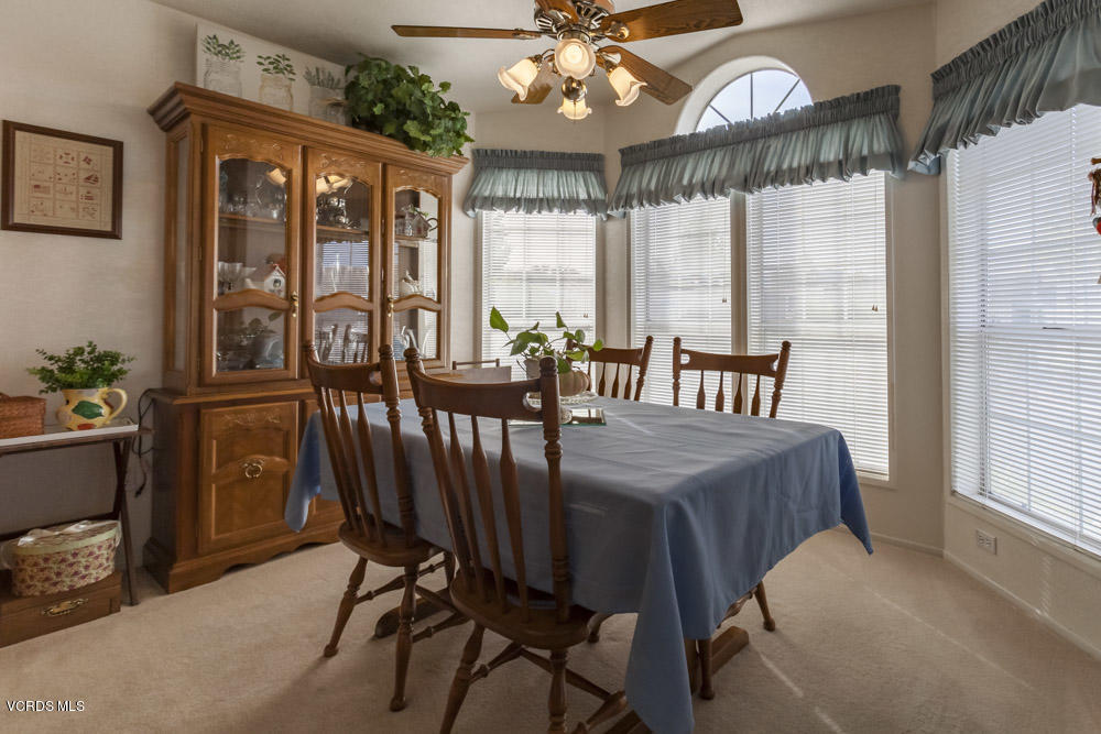 15750 Arroyo Drive, Unit 32 Moorpark, CA 93021 - Photo 12 of 26 a view of a dining room with furniture large windows and wooden floor
