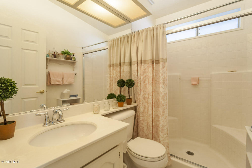 15750 Arroyo Drive, Unit 32 Moorpark, CA 93021 - Photo 17 of 26 a bathroom with a granite countertop sink toilet and shower