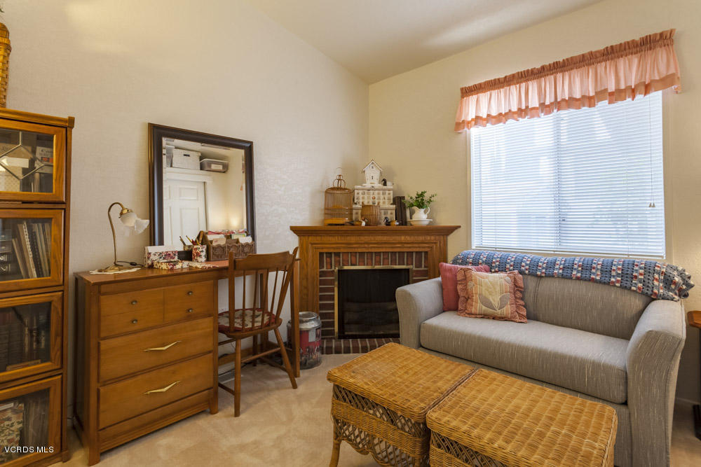 15750 Arroyo Drive, Unit 32 Moorpark, CA 93021 - Photo 19 of 26 a living room with furniture and a fireplace