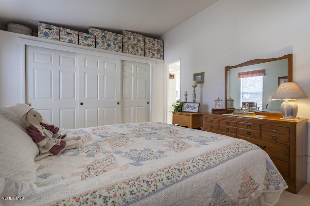 15750 Arroyo Drive, Unit 32 Moorpark, CA 93021 - Photo 21 of 26 a spacious bedroom with a bed and a dresser