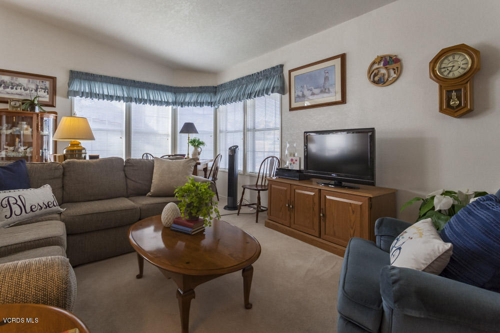 15750 Arroyo Drive, Unit 32 Moorpark, CA 93021 - Photo 7 of 26 a living room with furniture and a flat screen tv
