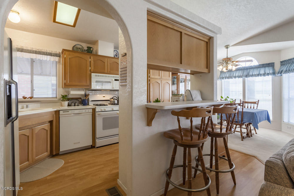 15750 Arroyo Drive, Unit 32 Moorpark, CA 93021 - Photo 8 of 26 a kitchen with stainless steel appliances a stove a sink and cabinets