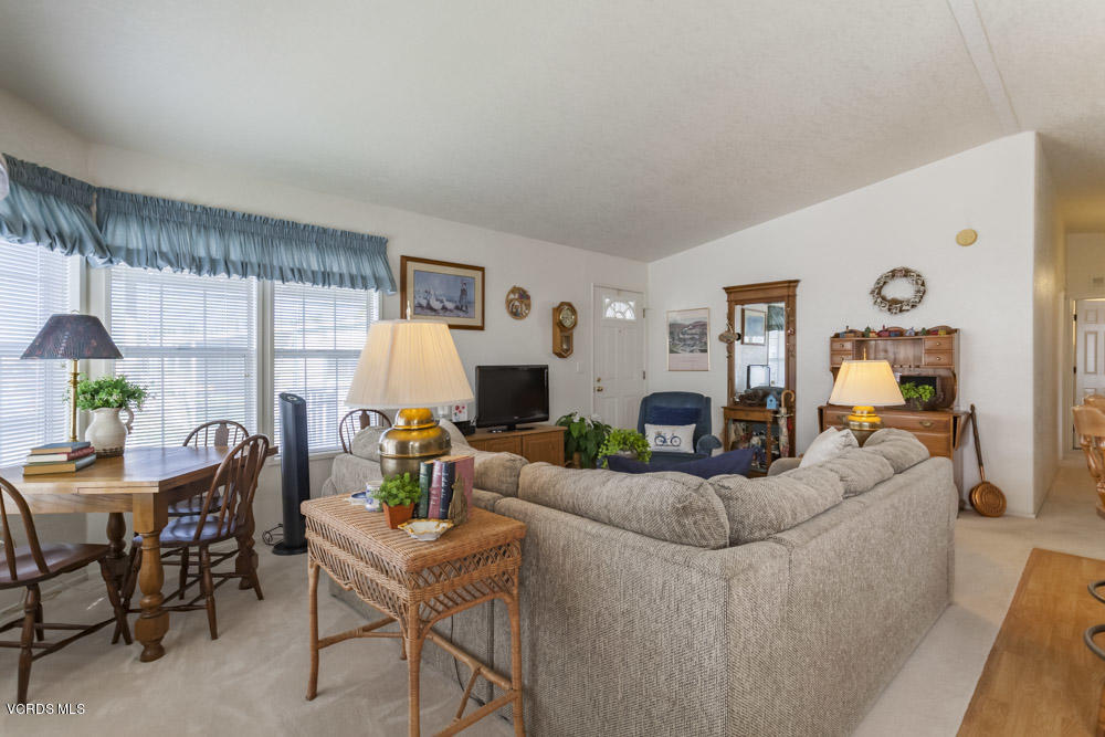 15750 Arroyo Drive, Unit 32 Moorpark, CA 93021 - Photo 10 of 26 a living room with fireplace furniture and a large window