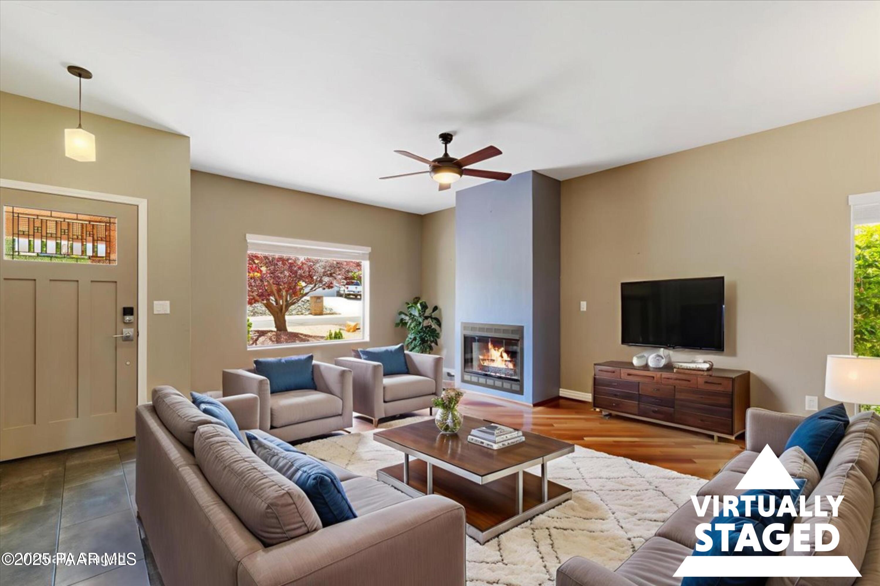 830 Hoosier Pass Prescott, AZ 86301 - Photo 2 of 41 a living room with furniture a fireplace and a flat screen tv