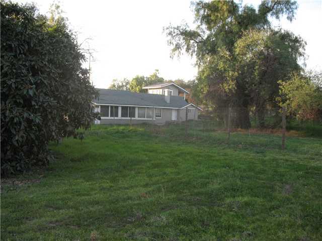 15338 Fruitvale Road Valley Center, CA 92082 - Photo 11 of 11 As seen from the front corner of the property. That's the loquat tree on the left. The property is fenced on both sides and the back and has additional cross fencing for animals, but isn't fenced across the front.