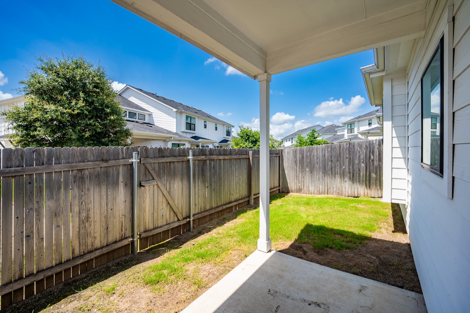 147 Waterside Road, Unit A Buda, TX 78610 - Photo 26 of 27 Private backyard with a wood fence creates a peaceful outdoor retreat.