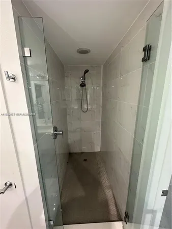 a bathroom with a glass shower door