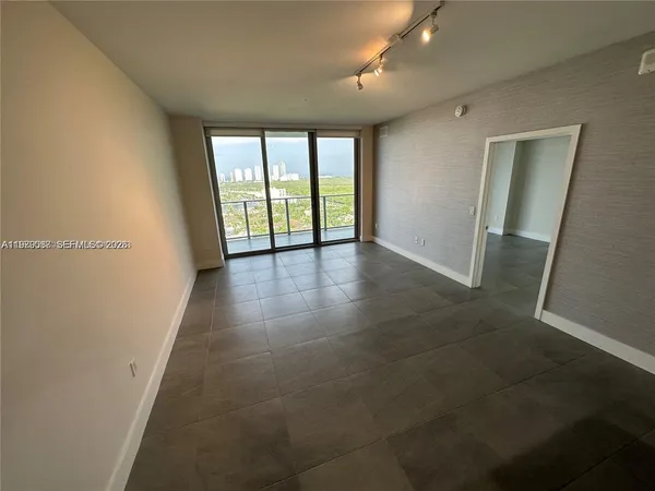 an empty room with large windows and city view