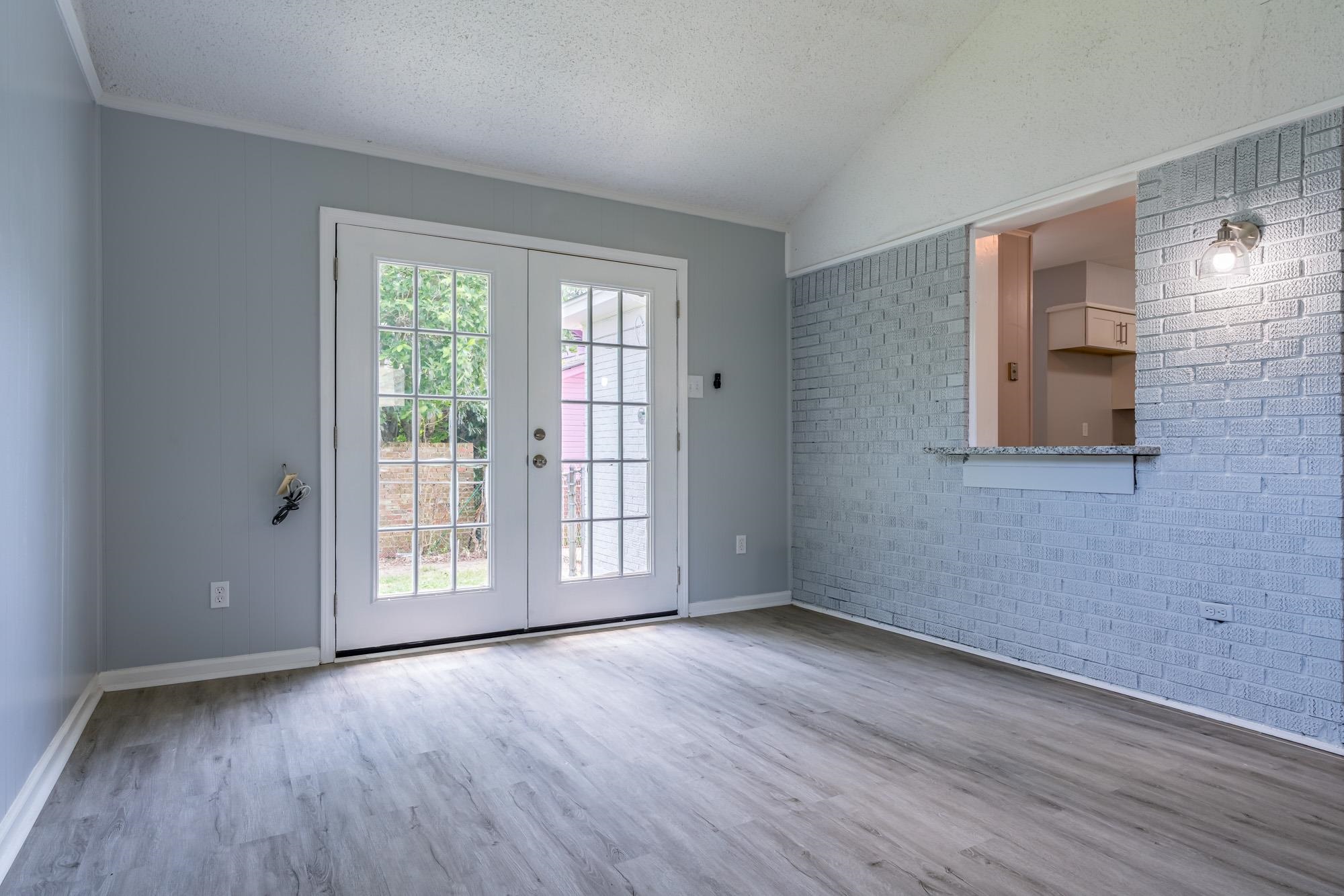 4606 Tulane Road Memphis, TN 38109 - Photo 17 of 25 a view of an empty room with wooden floor and a window