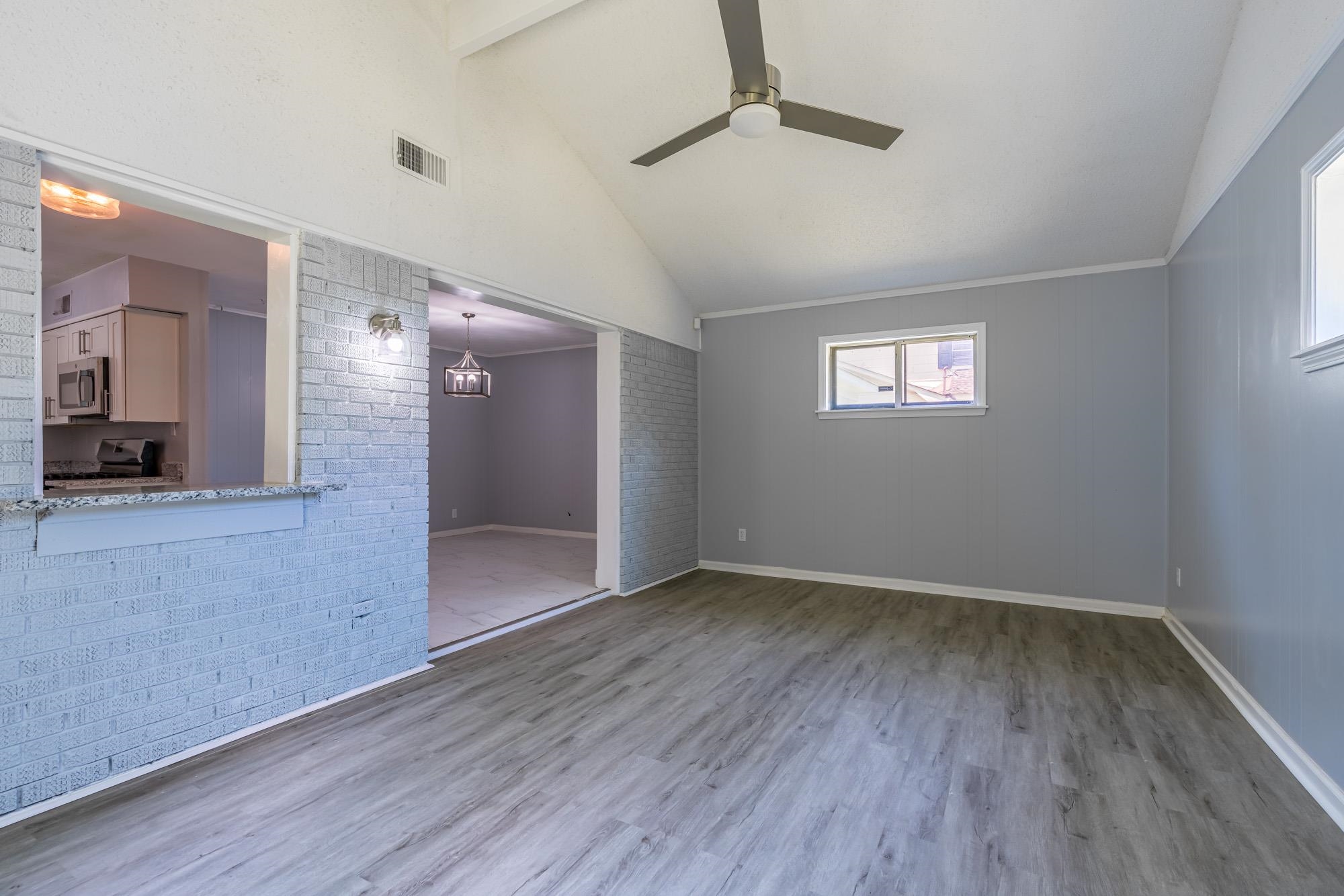 4606 Tulane Road Memphis, TN 38109 - Photo 18 of 25 a view of an empty room with wooden floor and a window