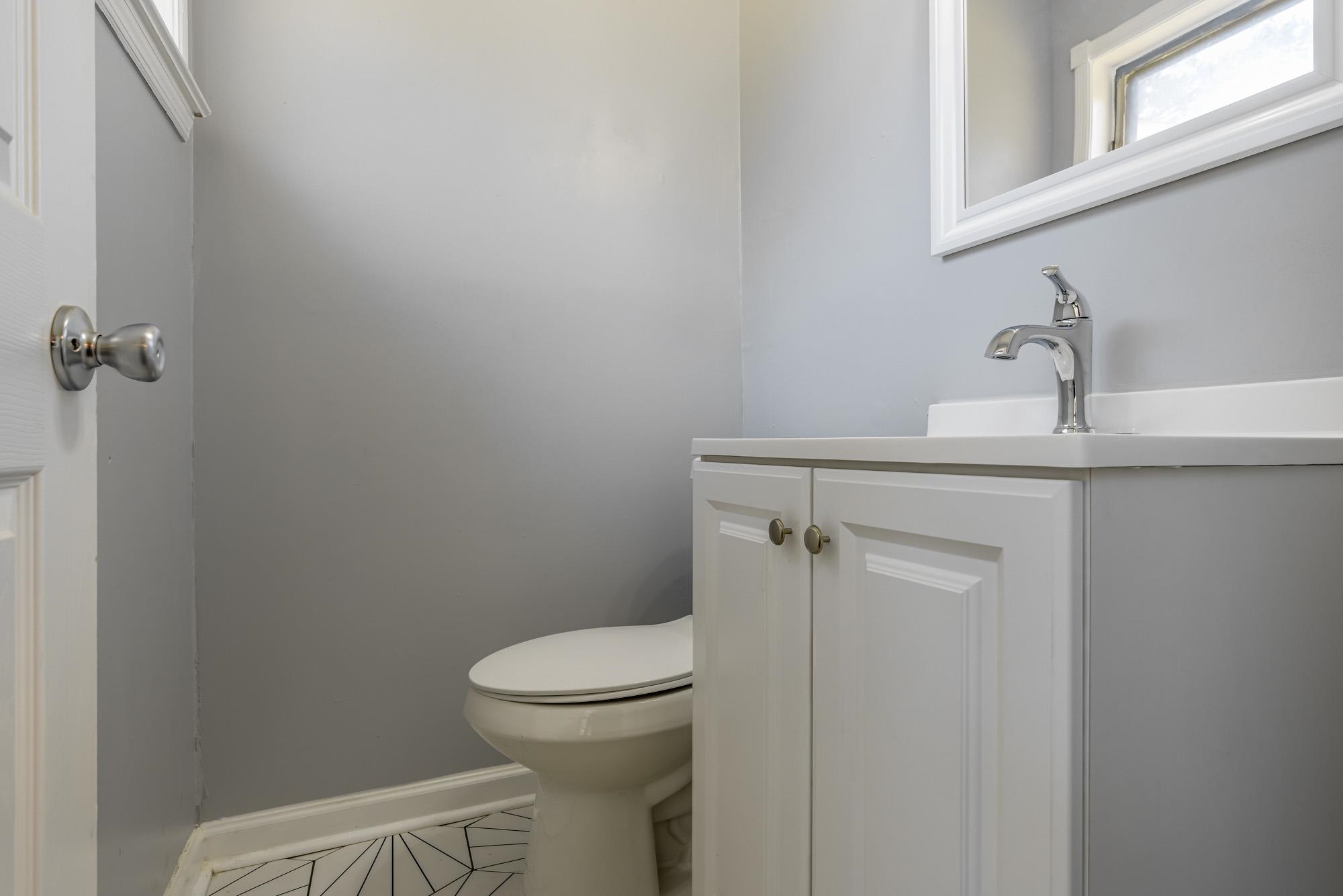 4606 Tulane Road Memphis, TN 38109 - Photo 25 of 25 a bathroom with a toilet a sink and mirror