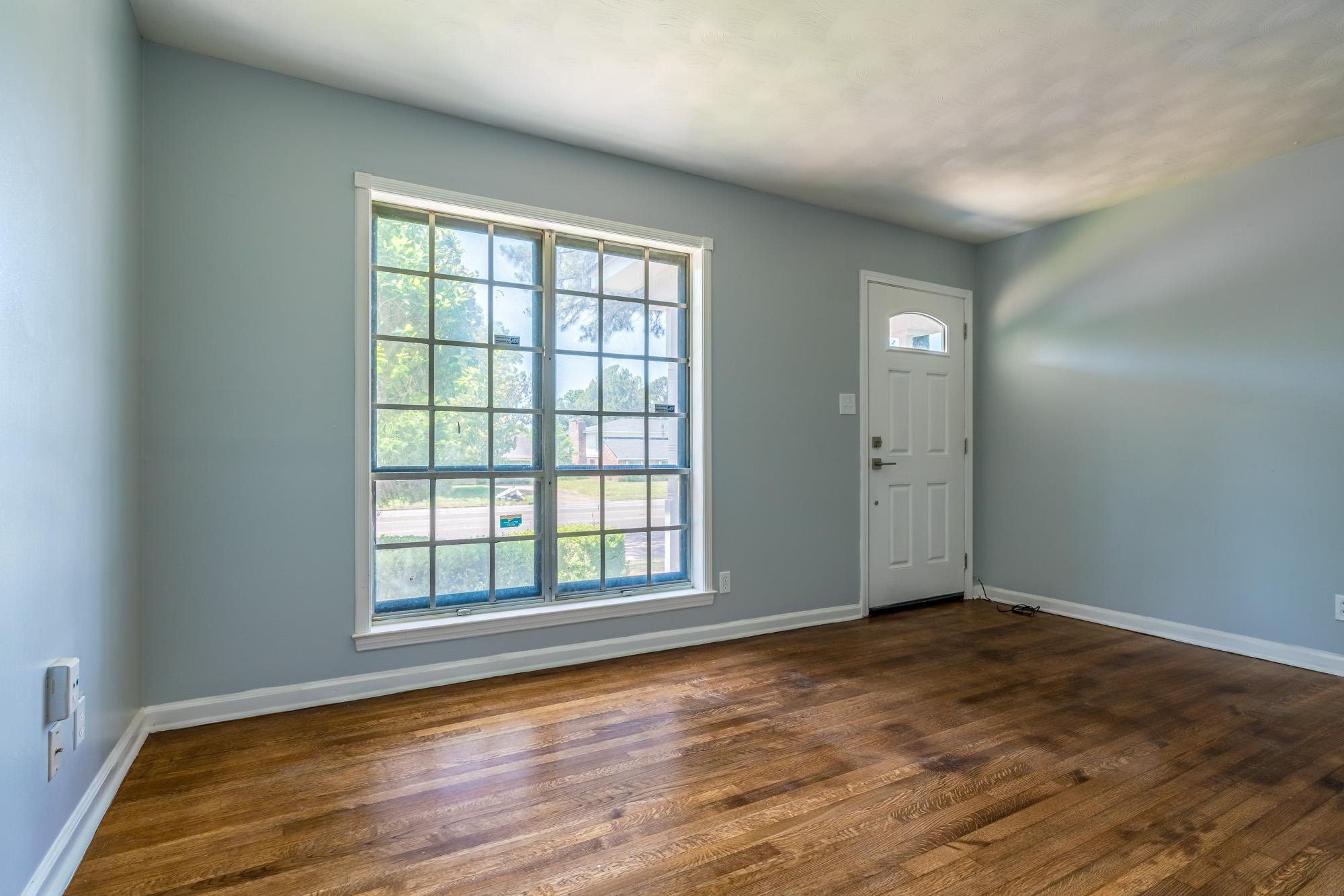 4606 Tulane Road Memphis, TN 38109 - Photo 6 of 25 an empty room with wooden floor and windows