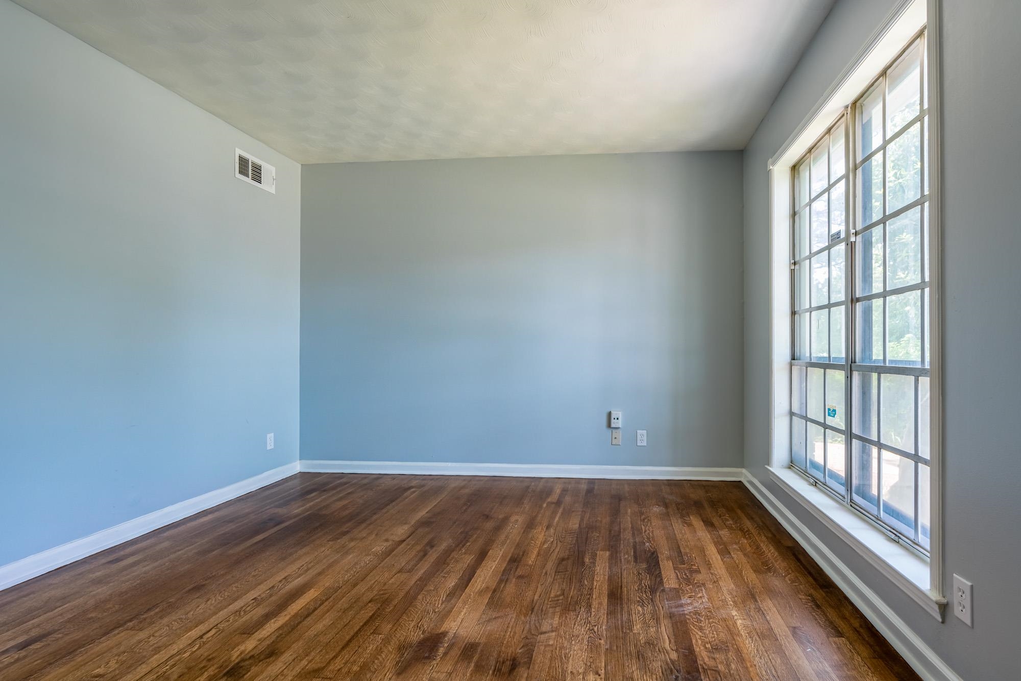 4606 Tulane Road Memphis, TN 38109 - Photo 7 of 25 wooden floor in an empty room with a window