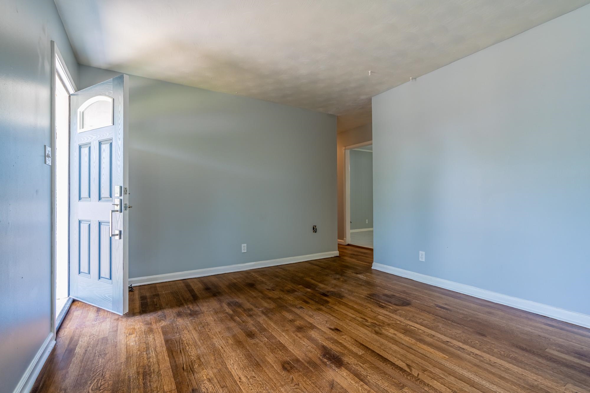 4606 Tulane Road Memphis, TN 38109 - Photo 8 of 25 a view of an empty room with wooden floor and a window