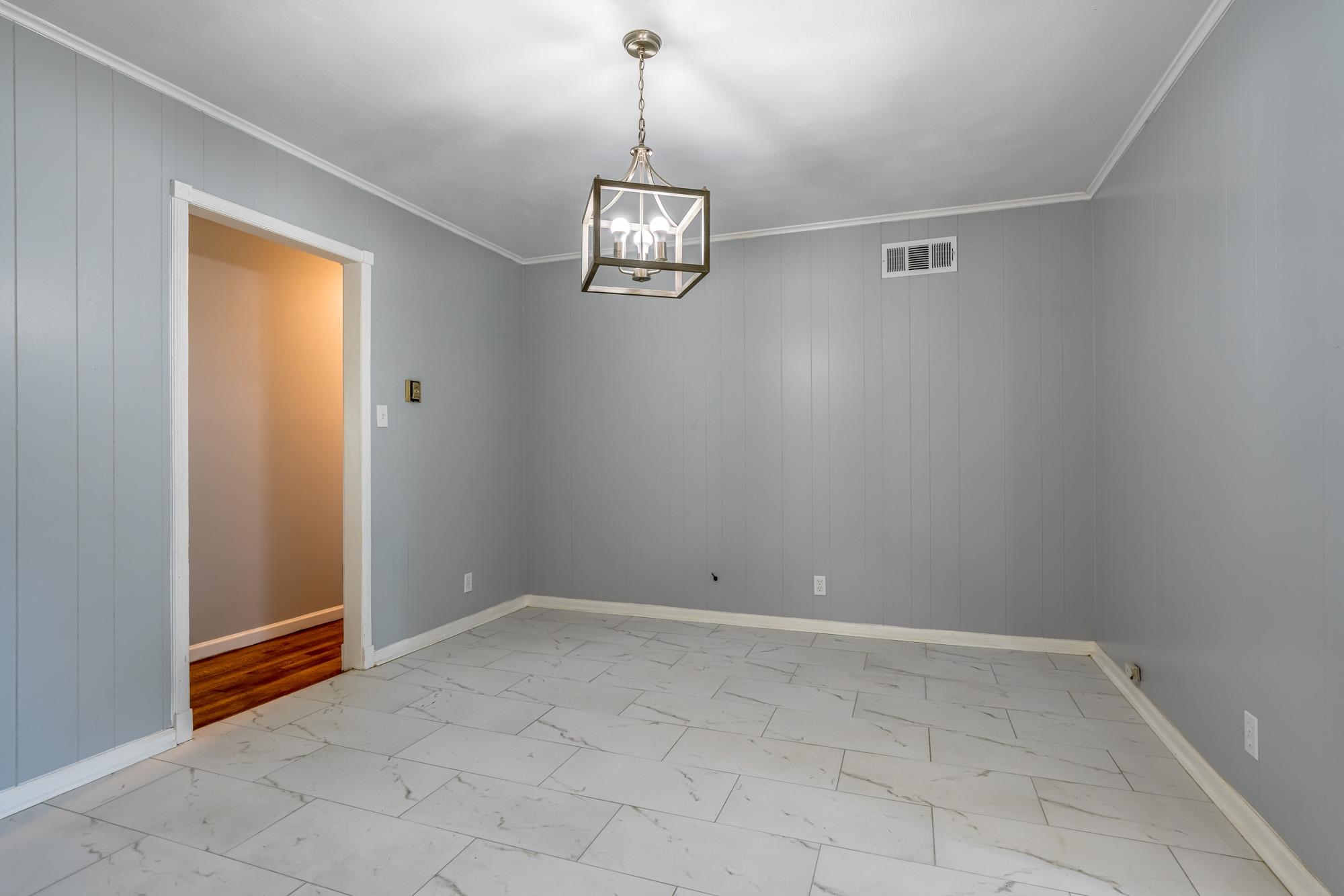 4606 Tulane Road Memphis, TN 38109 - Photo 10 of 25 a view of an empty room with a chandelier fan