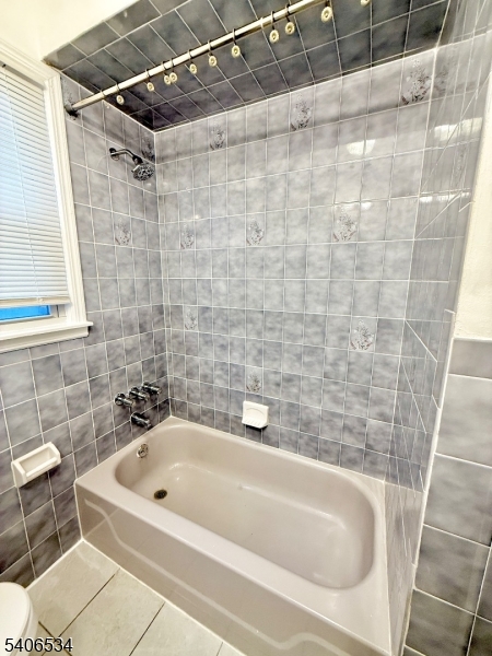 727 Pennington Street Elizabeth, NJ 07202 - Photo 11 of 18 a bathroom with a white bath tub and a shower