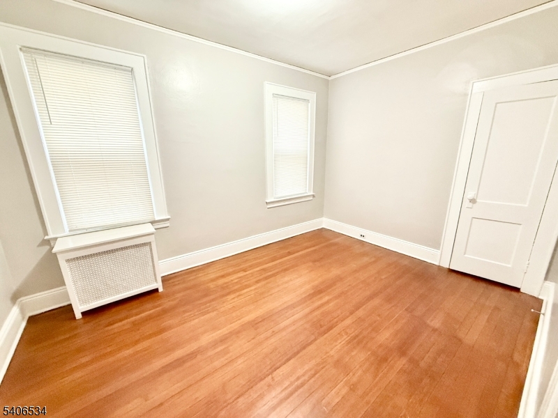 727 Pennington Street Elizabeth, NJ 07202 - Photo 14 of 18 an empty room with wooden floor and windows
