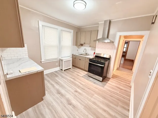 a kitchen with granite countertop a stove and a sink