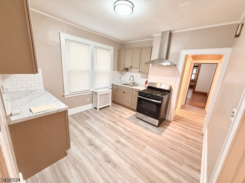 727 Pennington Street Elizabeth, NJ 07202 - Photo 16 of 18 a kitchen with granite countertop a stove and a sink