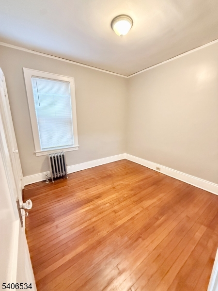 727 Pennington Street Elizabeth, NJ 07202 - Photo 18 of 18 a view of a room with wooden floor and cabinet