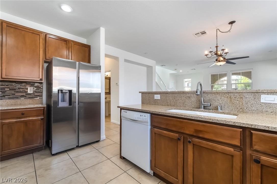 3175 Via Seranova Henderson, NV 89044 - Photo 15 of 45 This spacious kitchen offers ample cabinetry, modern appliances, and convenient open-concept living.