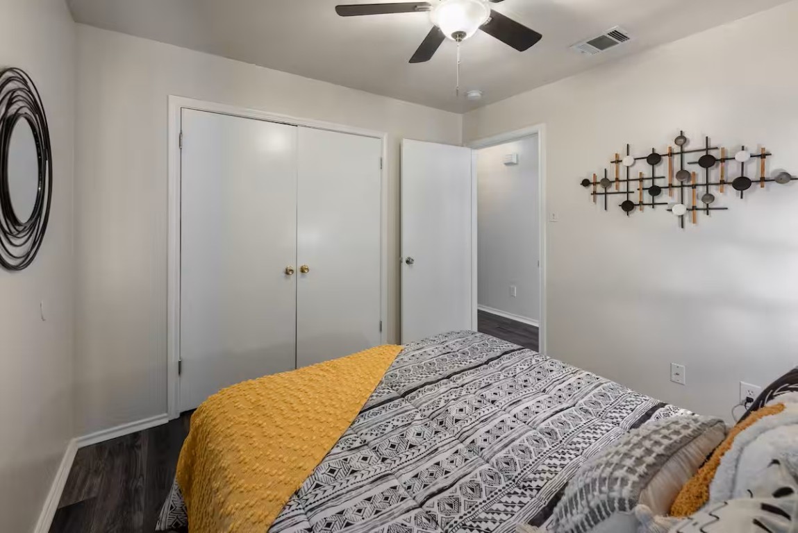 2304 Smith Branch Boulevard, Unit A Georgetown, TX 78626 - Photo 18 of 26 a bedroom with a large bed and a chandelier
