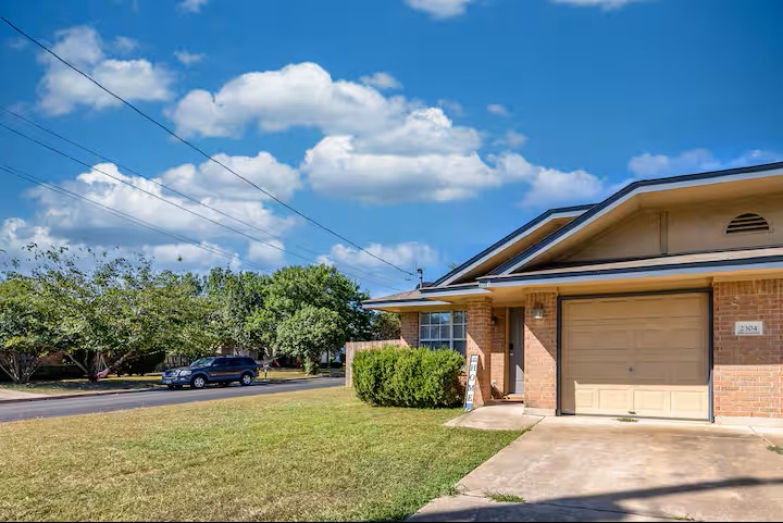 2304 Smith Branch Boulevard, Unit A Georgetown, TX 78626 - Photo 2 of 26 a front view of a house with garden