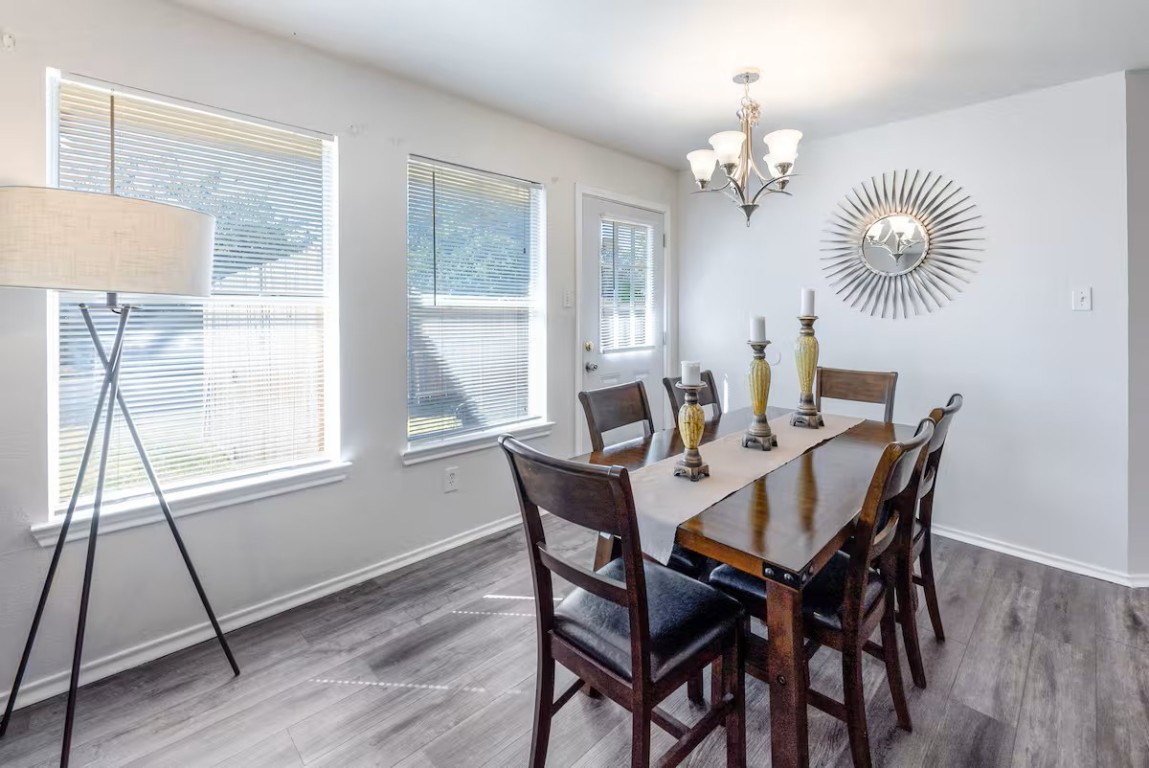 2304 Smith Branch Boulevard, Unit A Georgetown, TX 78626 - Photo 8 of 26 a view of a dining room with furniture wooden floor and chandelier