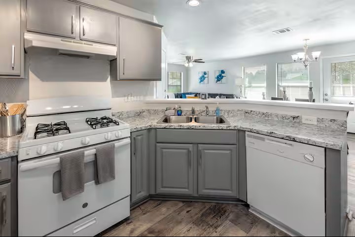 2304 Smith Branch Boulevard, Unit A Georgetown, TX 78626 - Photo 9 of 26 a kitchen with granite countertop cabinets stainless steel appliances and a sink