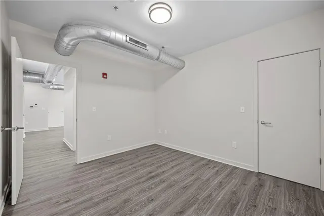 a view of a room with wooden floor