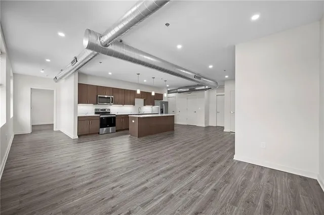 a view of kitchen and kitchen with a refrigerator