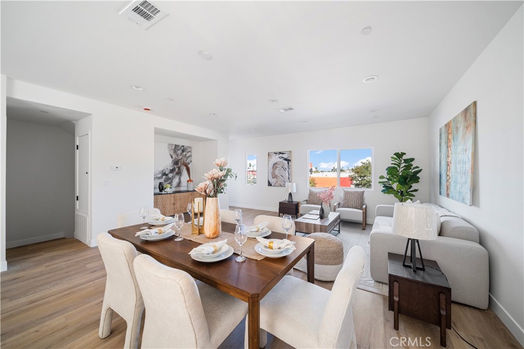 7692 9th Street, Unit 113 Buena Park, CA 90621 - Photo 12 of 41 a view of a dining room with furniture and wooden floor