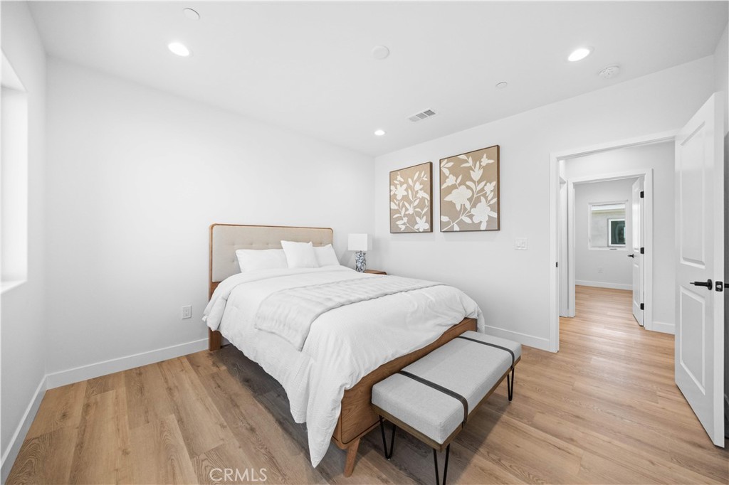 7692 9th Street, Unit 113 Buena Park, CA 90621 - Photo 16 of 41 a bedroom with a bed and wooden floor