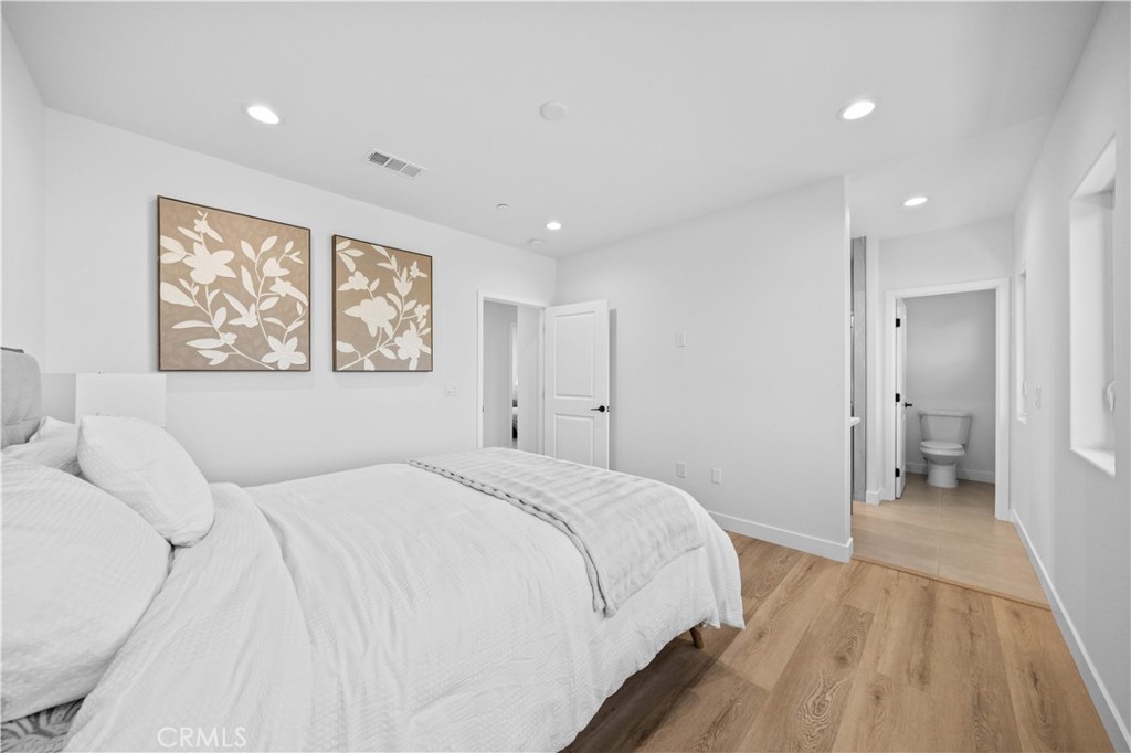 7692 9th Street, Unit 113 Buena Park, CA 90621 - Photo 18 of 41 a spacious bedroom with a bed and a painting on the wall