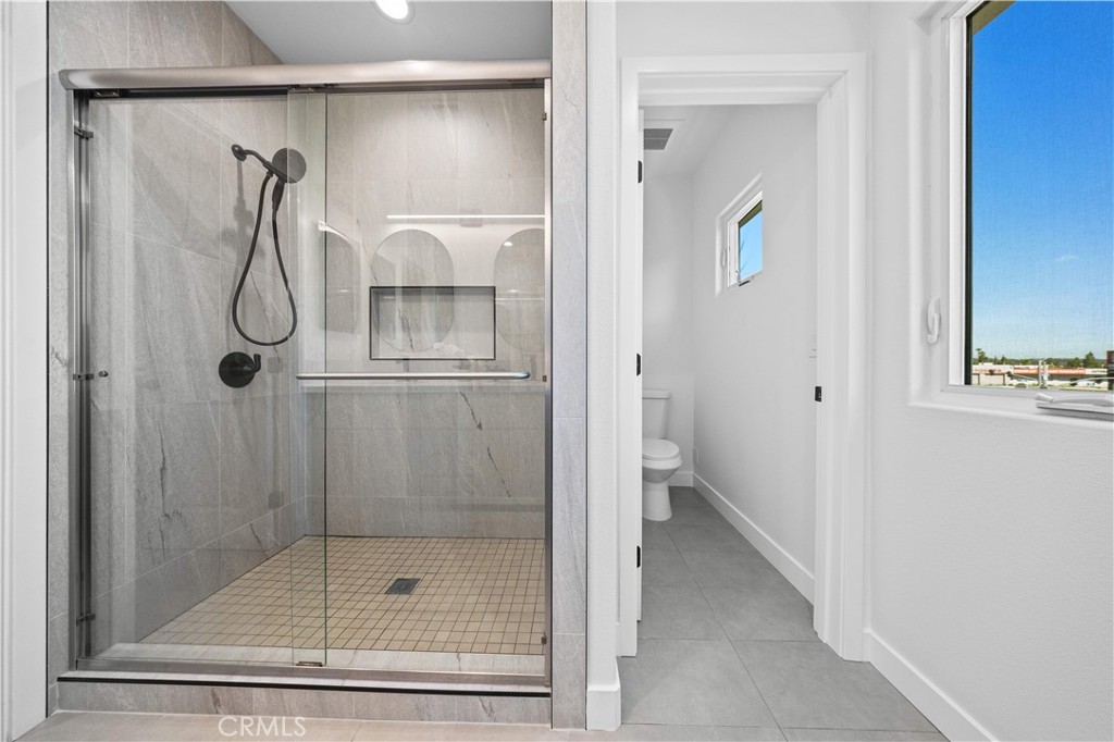 7692 9th Street, Unit 113 Buena Park, CA 90621 - Photo 22 of 41 a bathroom with a glass shower door