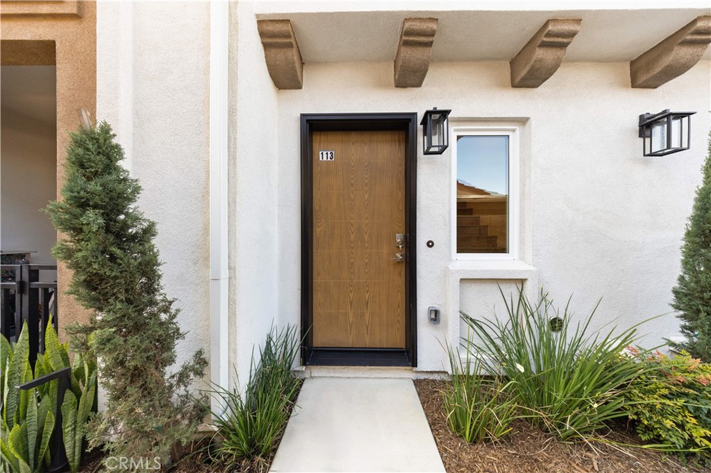 7692 9th Street, Unit 113 Buena Park, CA 90621 - Photo 3 of 41 a front view of a house with a yard