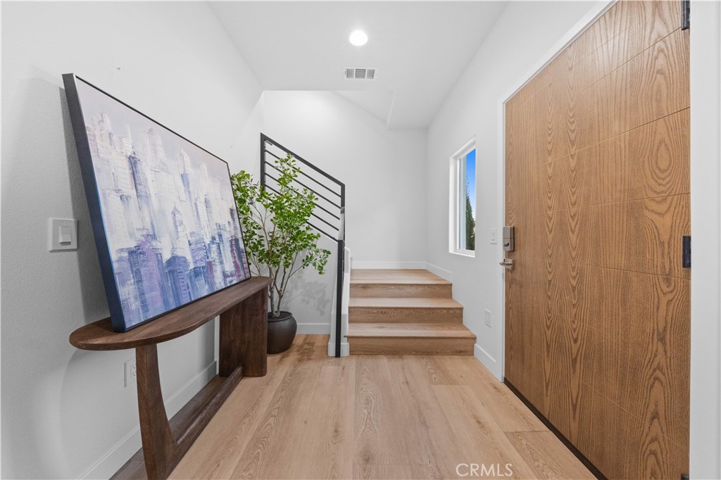 7692 9th Street, Unit 113 Buena Park, CA 90621 - Photo 6 of 41 a view of entryway with stairs and wooden floor