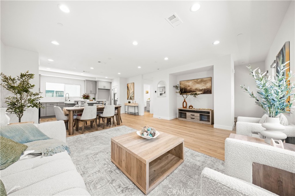 7692 9th Street, Unit 113 Buena Park, CA 90621 - Photo 8 of 41 a living room with furniture dining table a rug and kitchen view