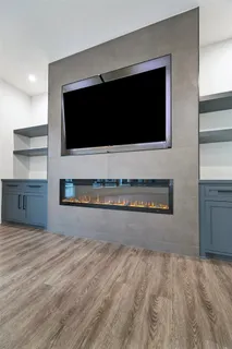 a living room with a flat screen tv and a fireplace