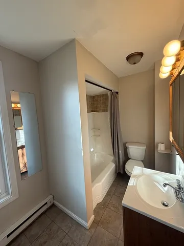 a bathroom with a sink and mirror with toilet