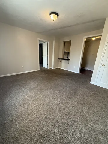 a view of a big room with windows and cabinet