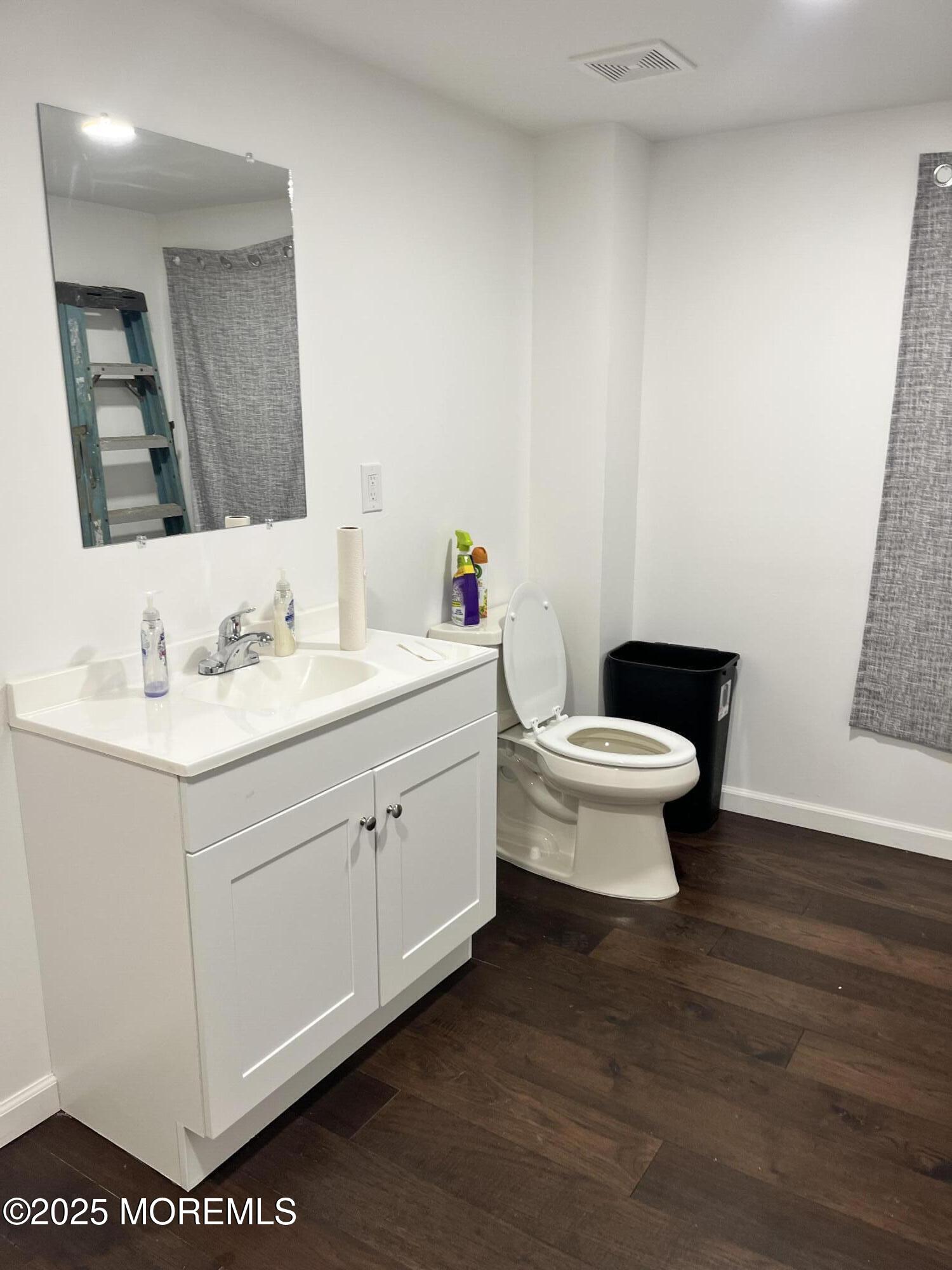 Pinebrook Road Tinton Falls, NJ 07724 - Photo 10 of 13 a bathroom with a toilet sink and mirror