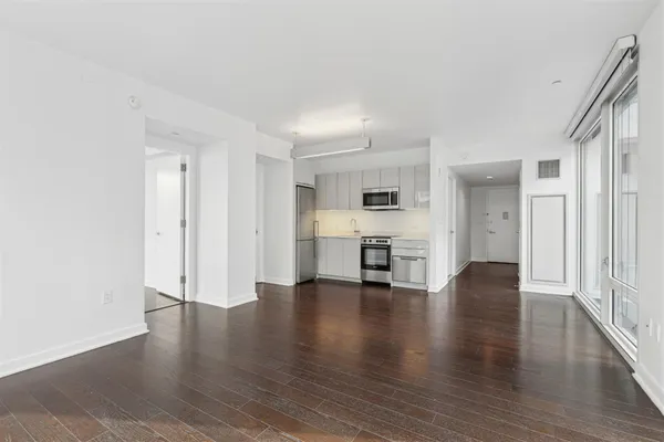 a view of empty room with wooden floor
