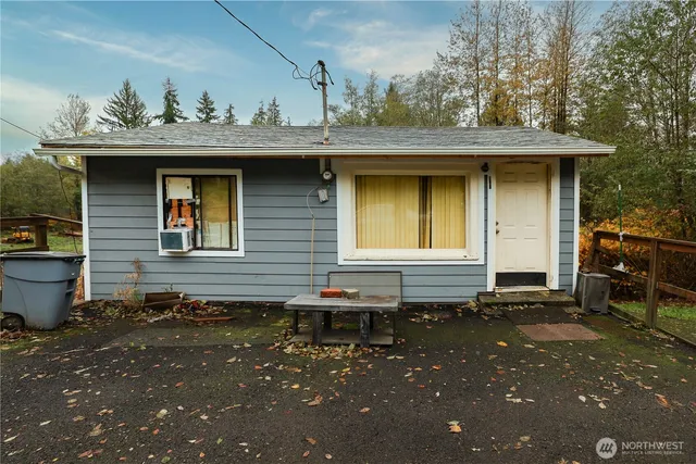 a backyard of a house with table and chairs
